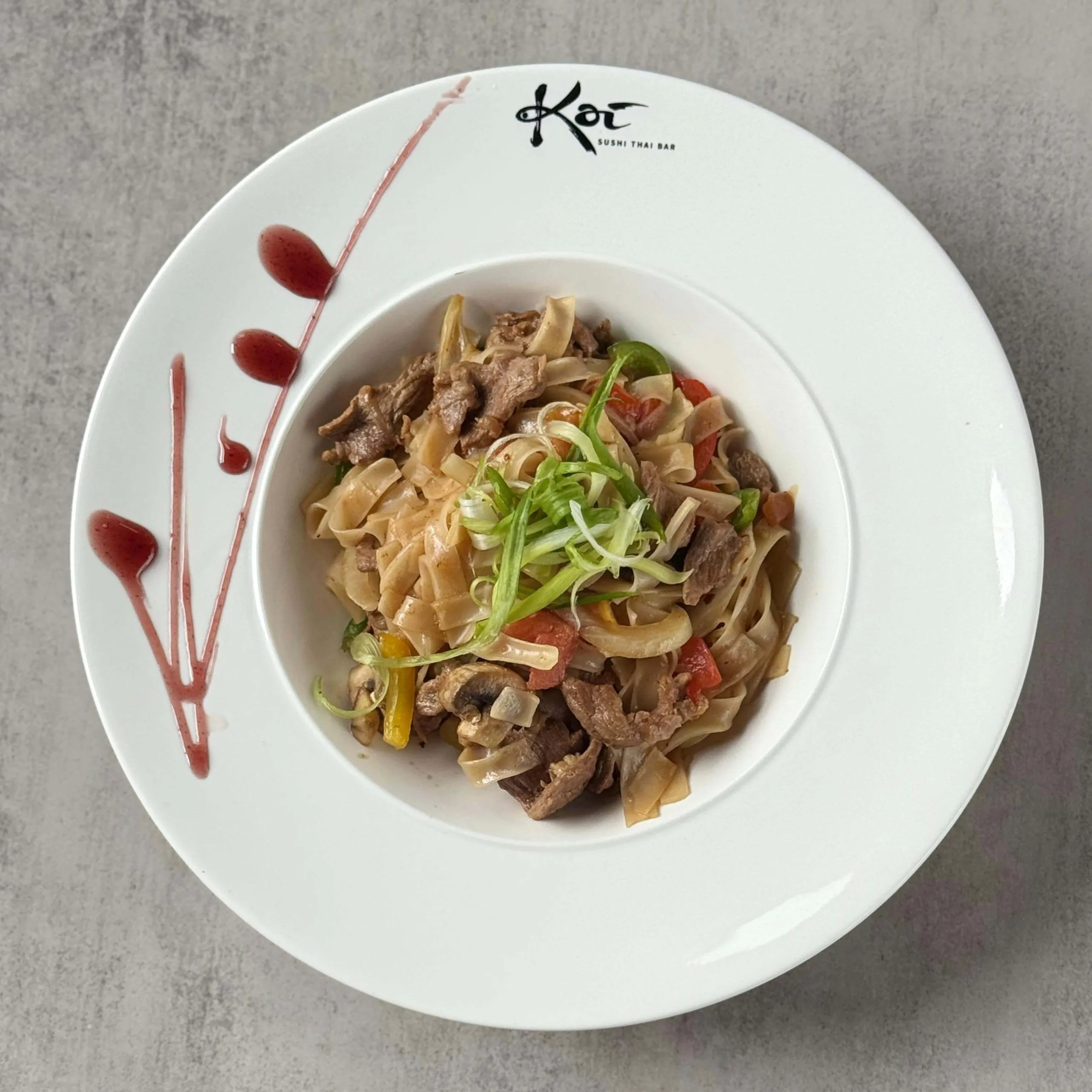 Stir - fried rice noodles with beef, peppers, mushrooms, and scallions